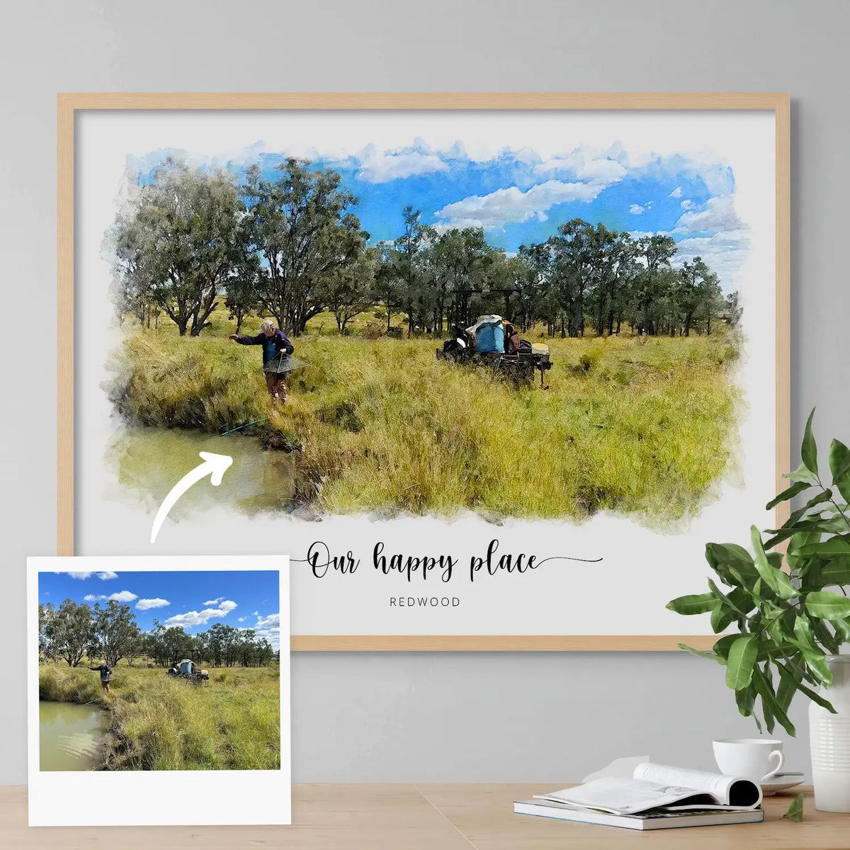 A snapshot of a person by a pond in tall grass, beside its watercolor-style portrait in a light oak frame