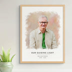 Watercolor-style memorial portrait of a man in glasses and a green shirt, in a light oak frame, 'Our Guiding Light'