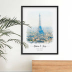 Watercolor-style portrait of the Eiffel Tower over Paris rooftops, framed in black, with names and a date beneath